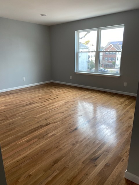 Empty living room with polished hardwood floor in Maplewood NJ