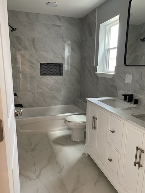 Spotless residential bathroom with marble tile and vanity in Union NJ